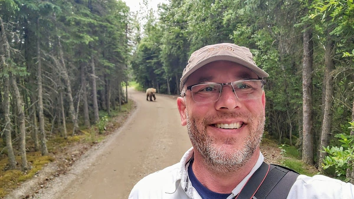 Tim with a bear behind him, Alaska